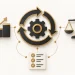 Improvement arrows surround a gear, linked to a chart, balance and checklist.