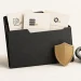 A charcoal folder holding evidence cards beside a gold shield and grey chain link.